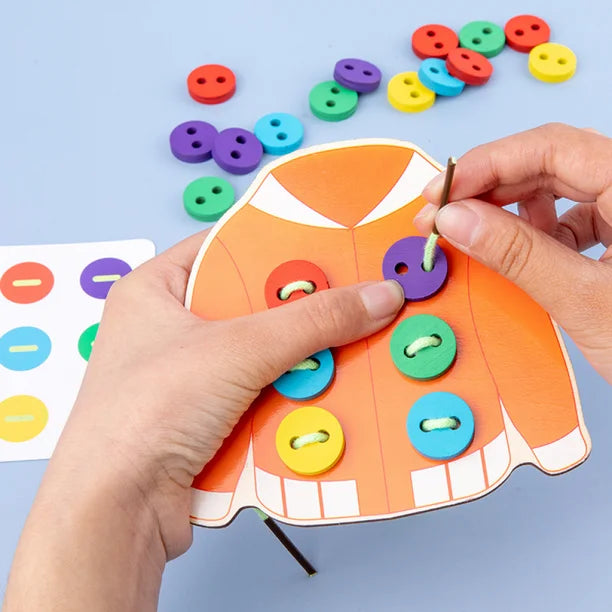 Toddler threading wooden button with rope